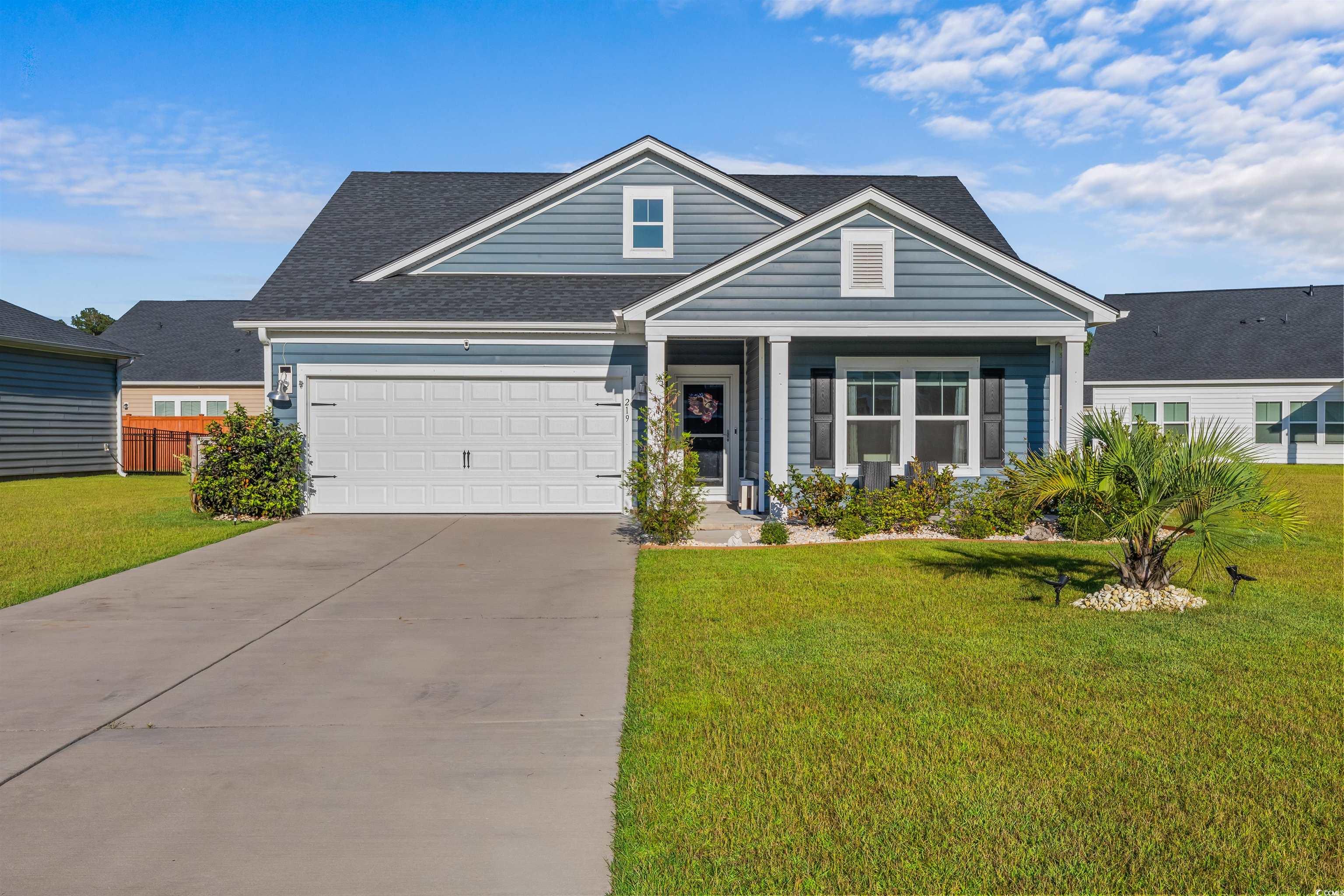 View of front facade with a garage and a front yar