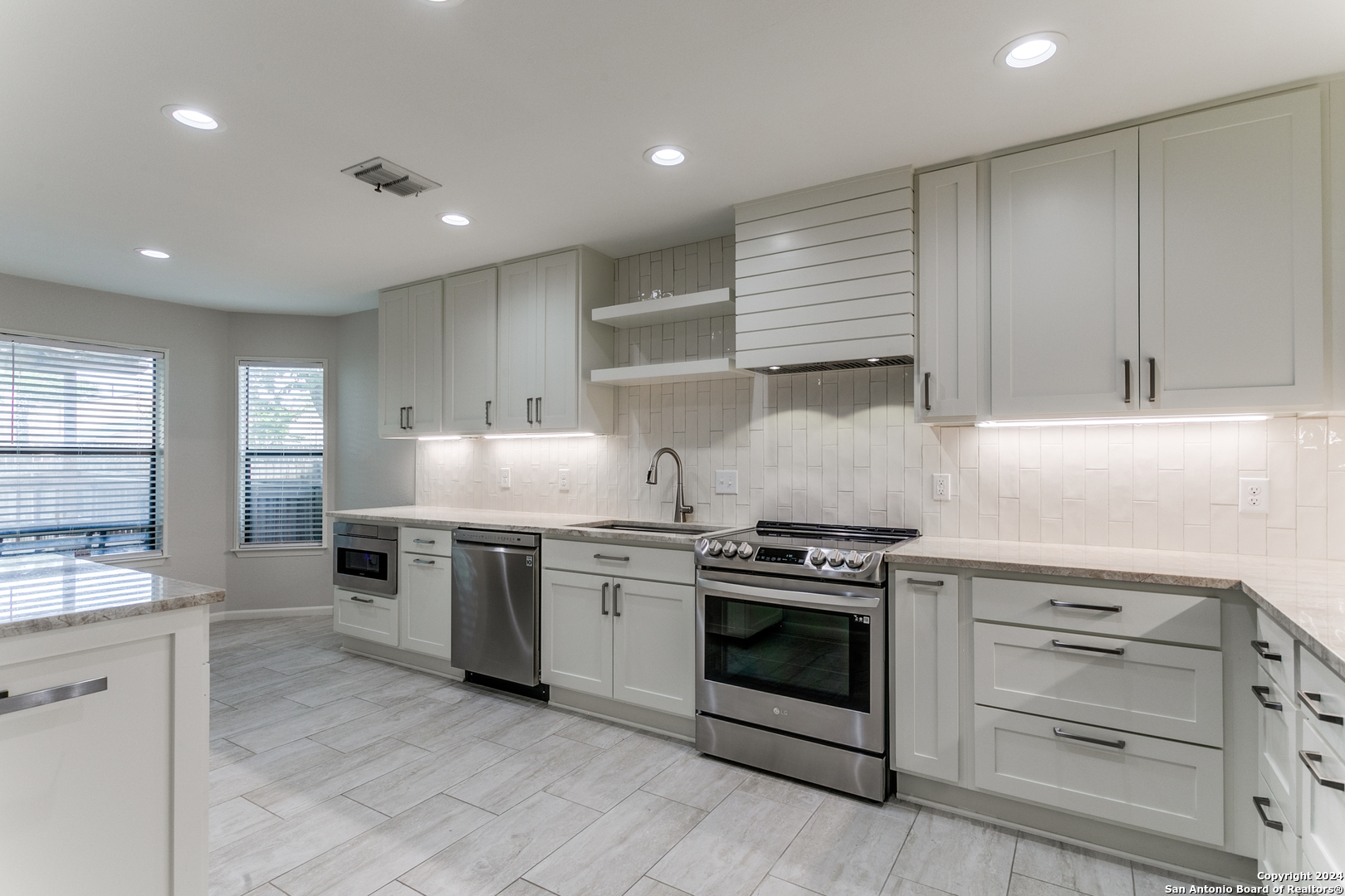 a kitchen with stainless steel appliances granite countertop a stove and a sink