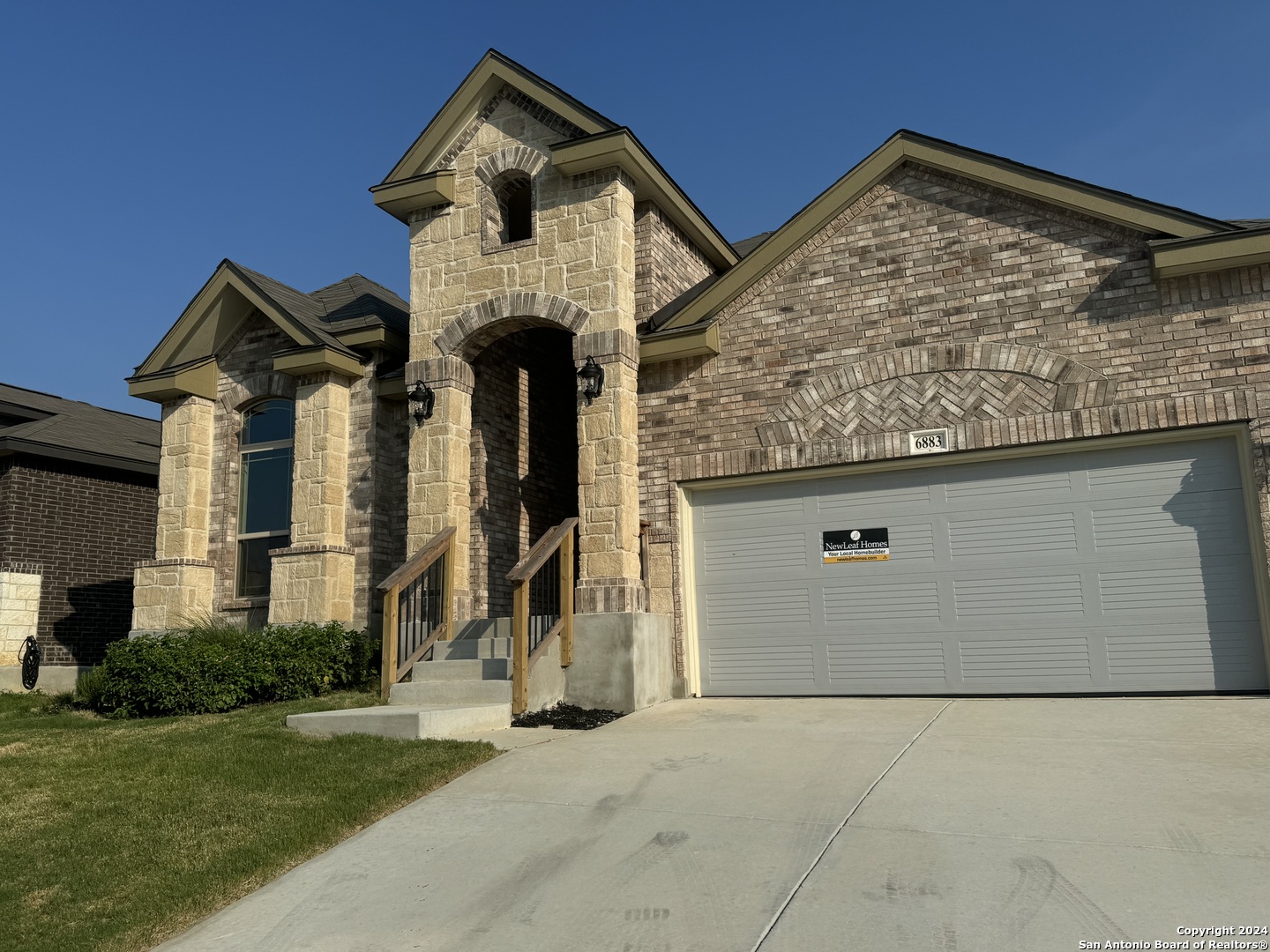 front view of a house with a small yard