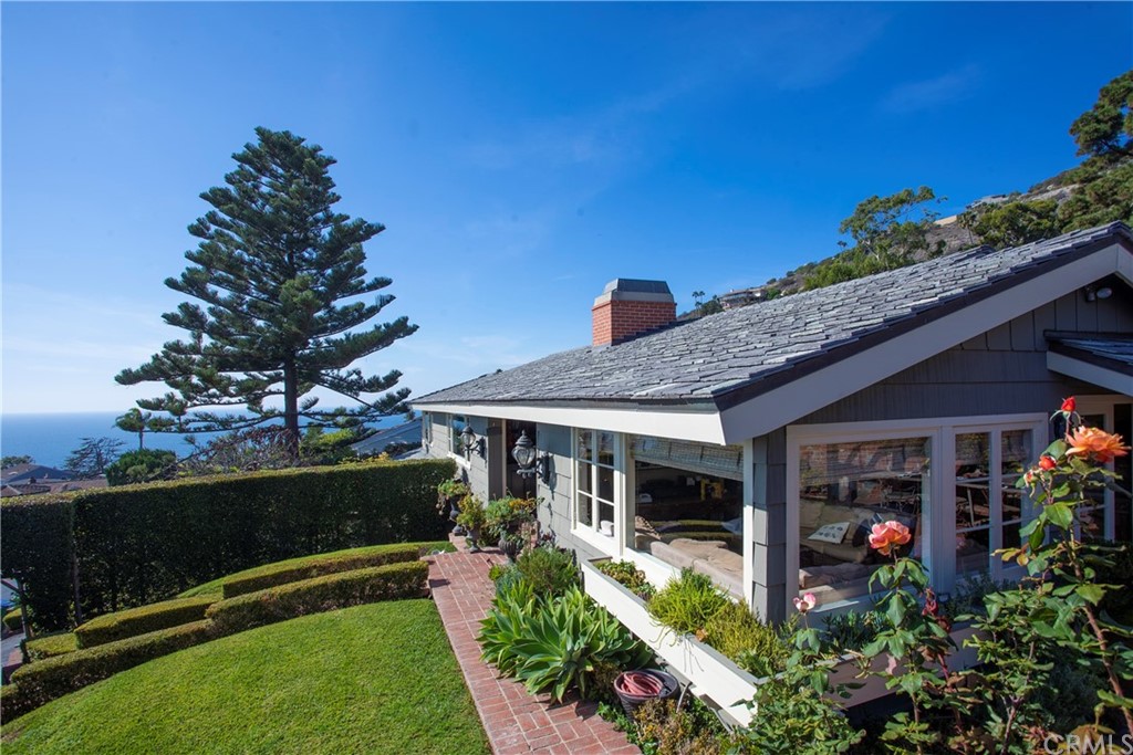 a front view of a house with a garden