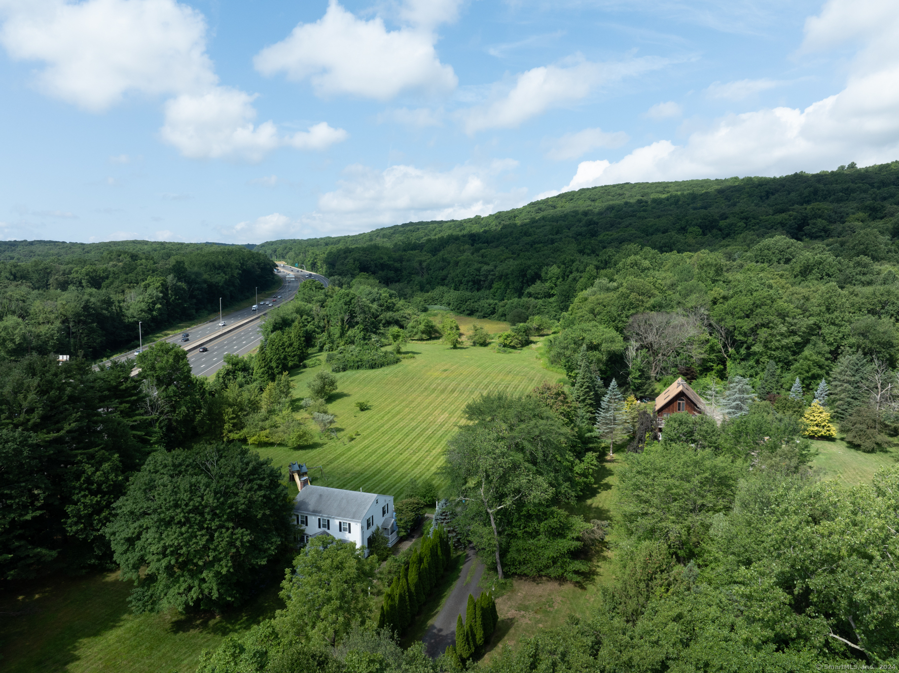 a view of a green field with lots of bushes