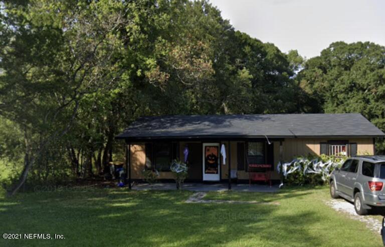 a view of a house with garden and sitting area