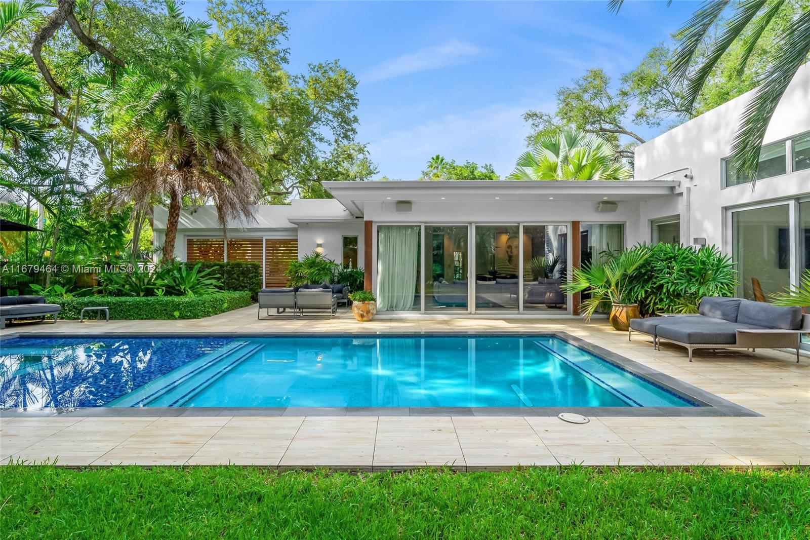 a view of swimming pool with outdoor seating and a garden