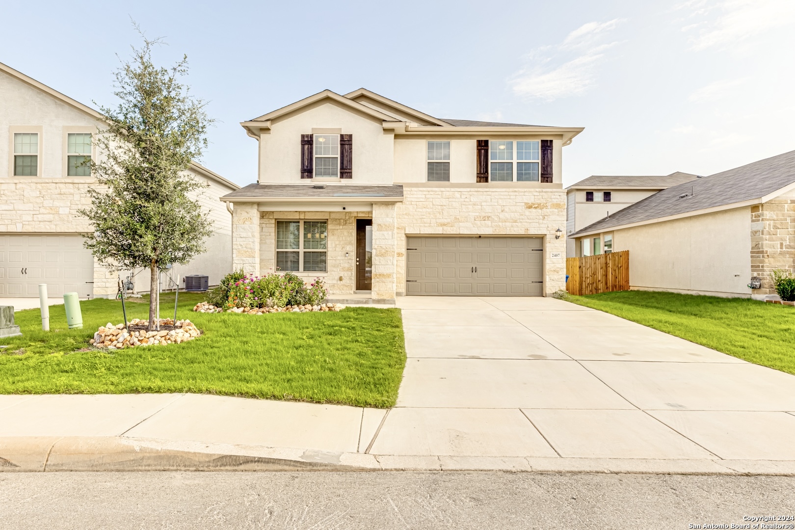 a front view of a house with a yard and garage