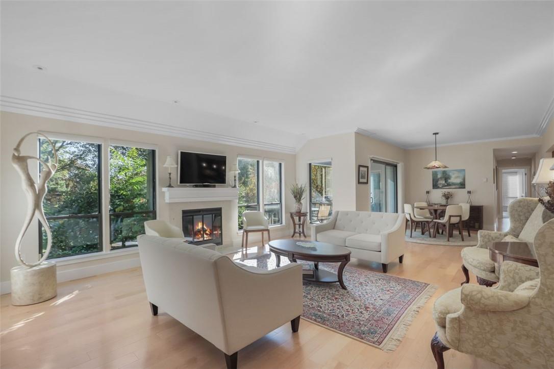 a living room with fireplace furniture and a floor to ceiling window