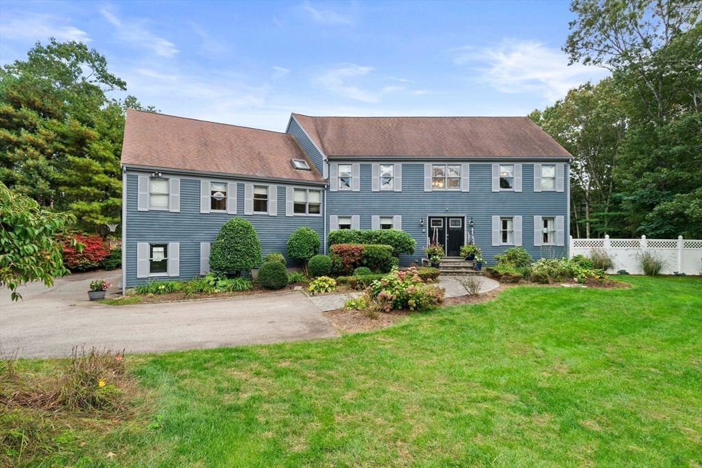 a front view of a house with a garden and porch