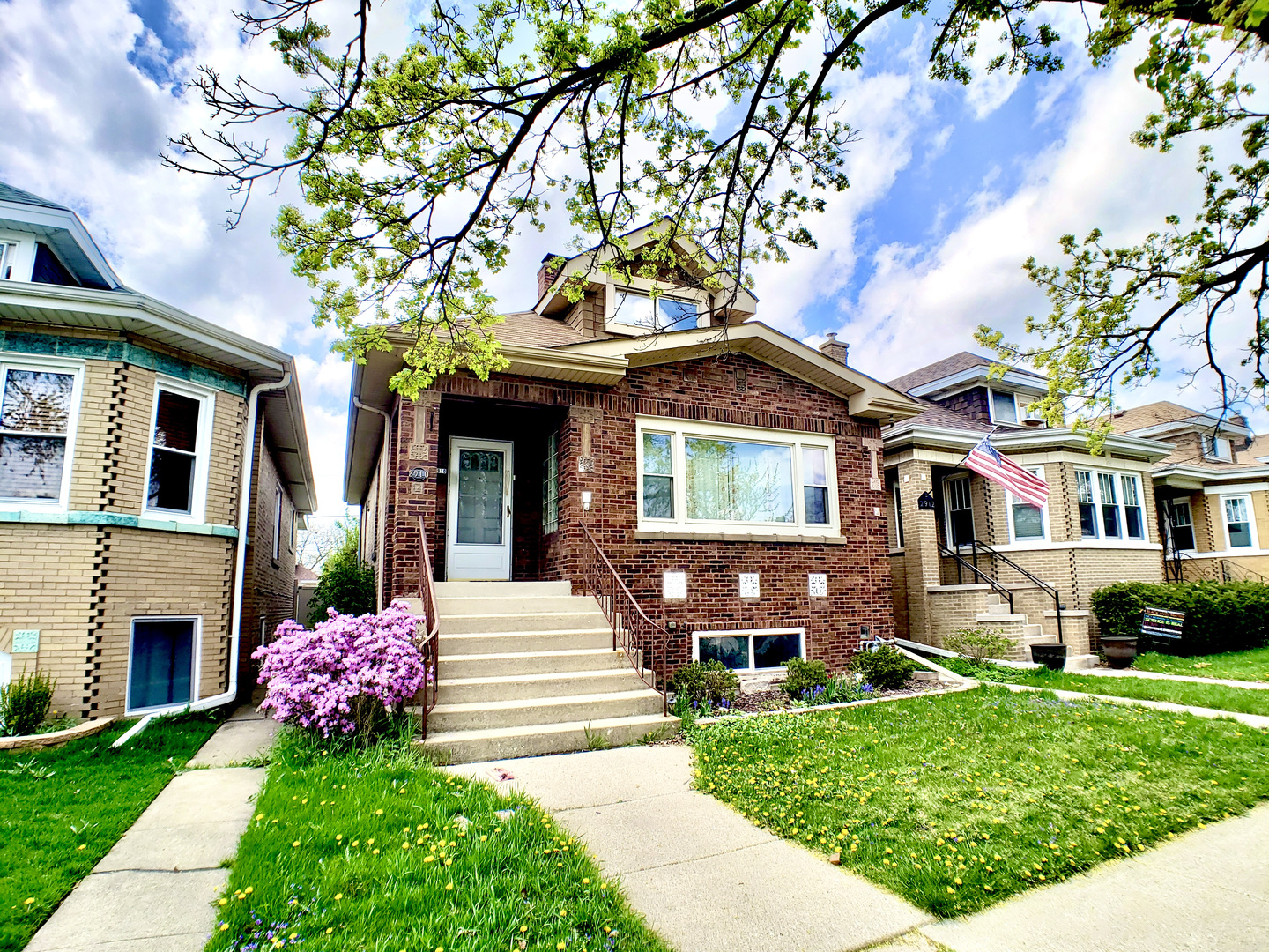 a front view of a house with a garden