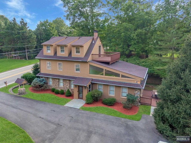 a aerial view of a house with a yard and potted plants