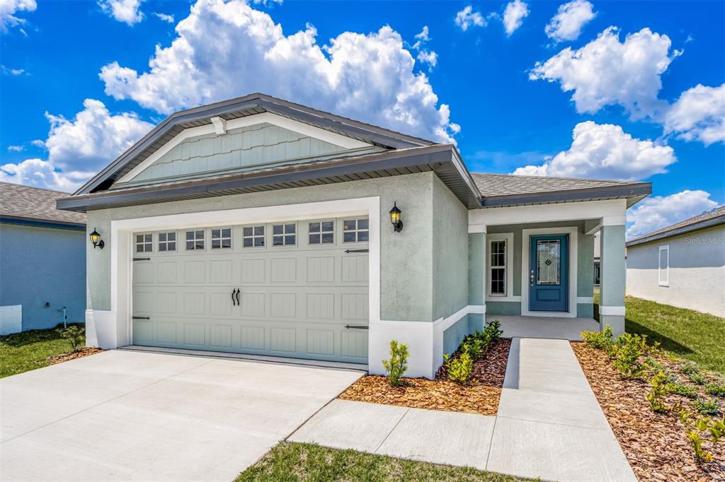 a front view of a house with a garage