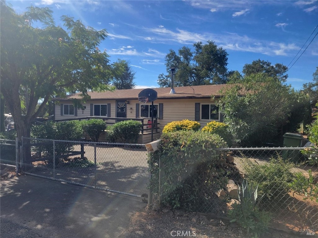 a view of a house with a yard and a patio