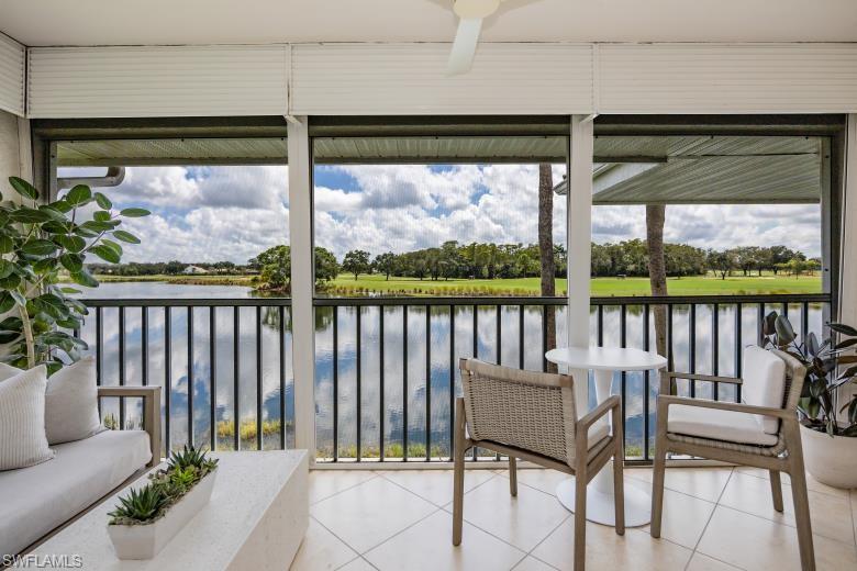 a balcony with table and chairs