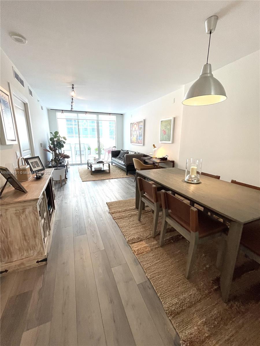 a view of a workspace with furniture window and wooden floor