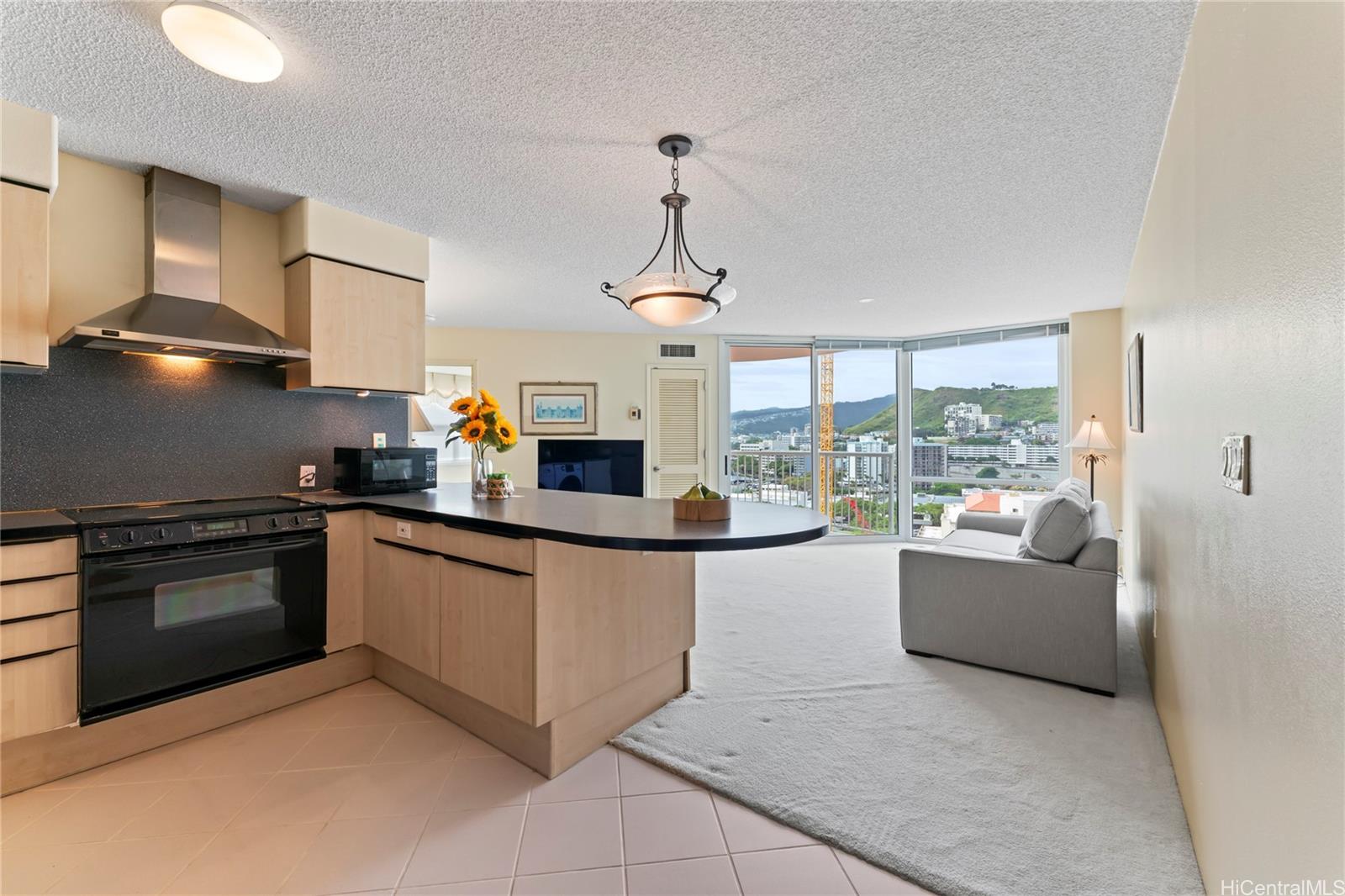 a kitchen with granite countertop a stove and a sink