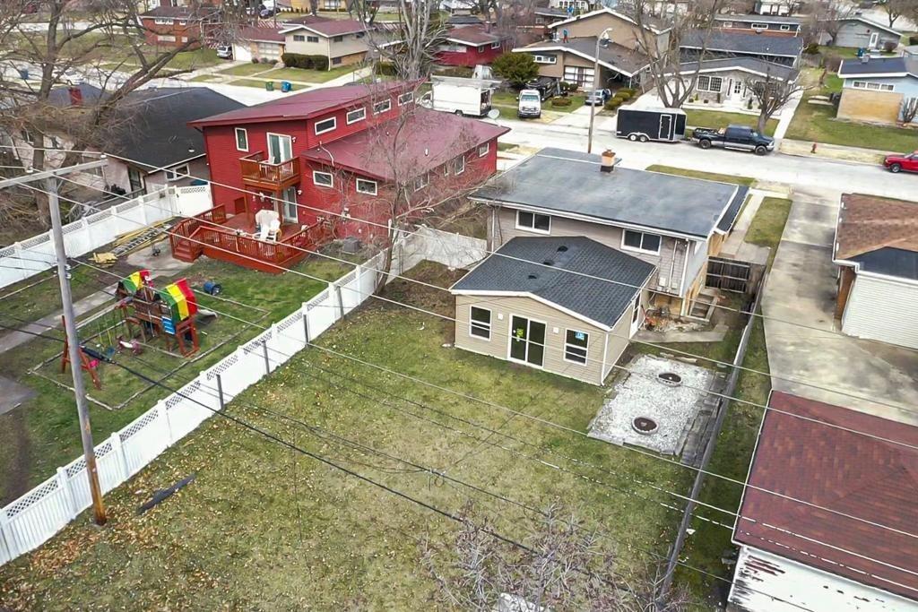 an aerial view of residential houses with outdoor space