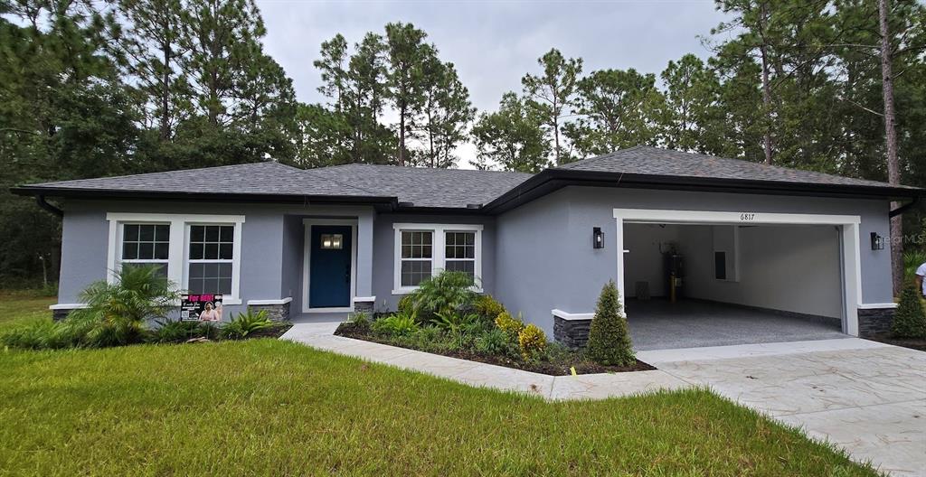 a front view of house with garage and yard