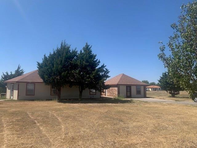 a front view of house with yard and trees