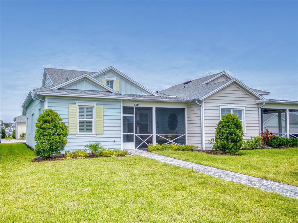 a front view of house with yard and green space