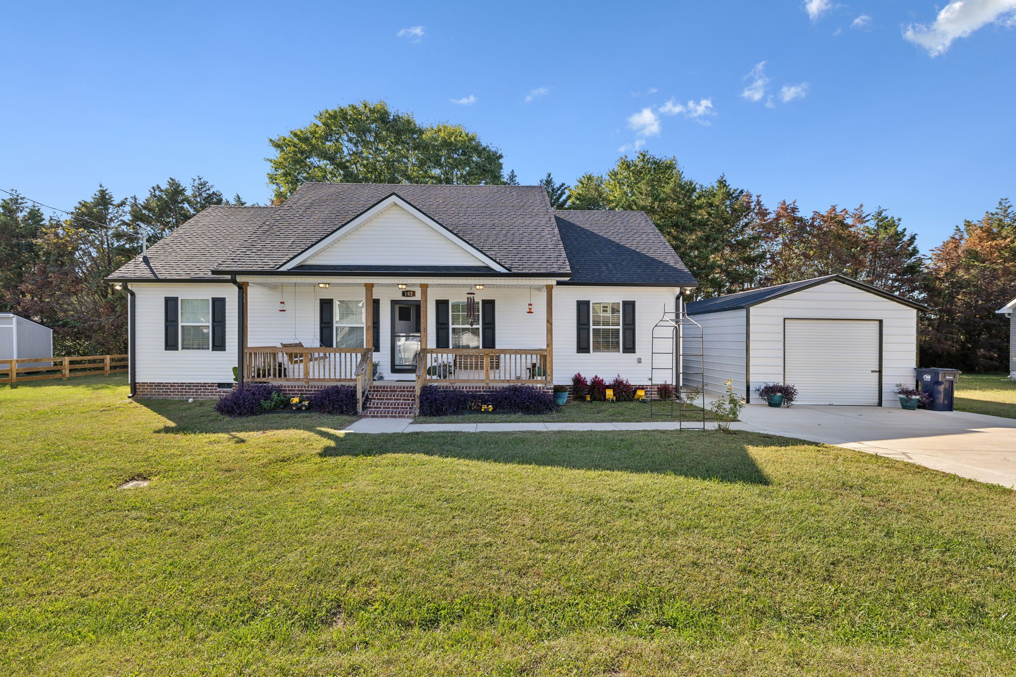 a house view with swimming pool and garden space