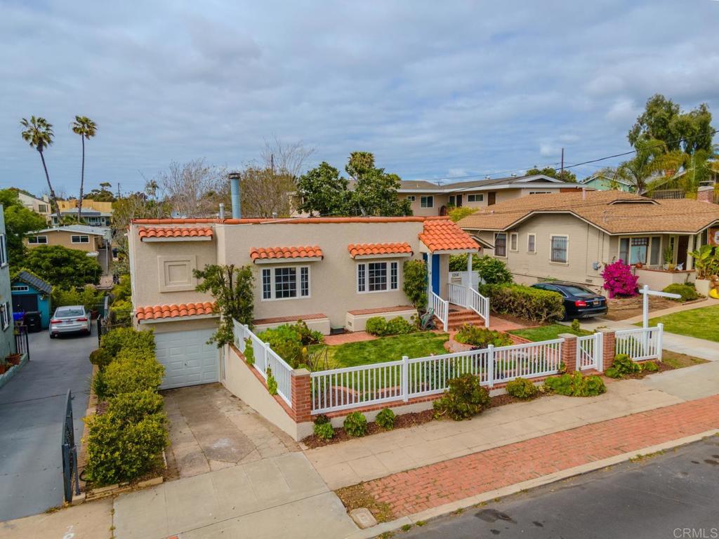 an aerial view of a house with sitting area and garden