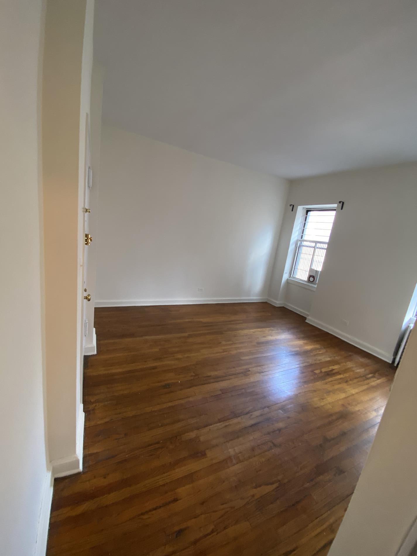 a view of wooden floor and windows in a room