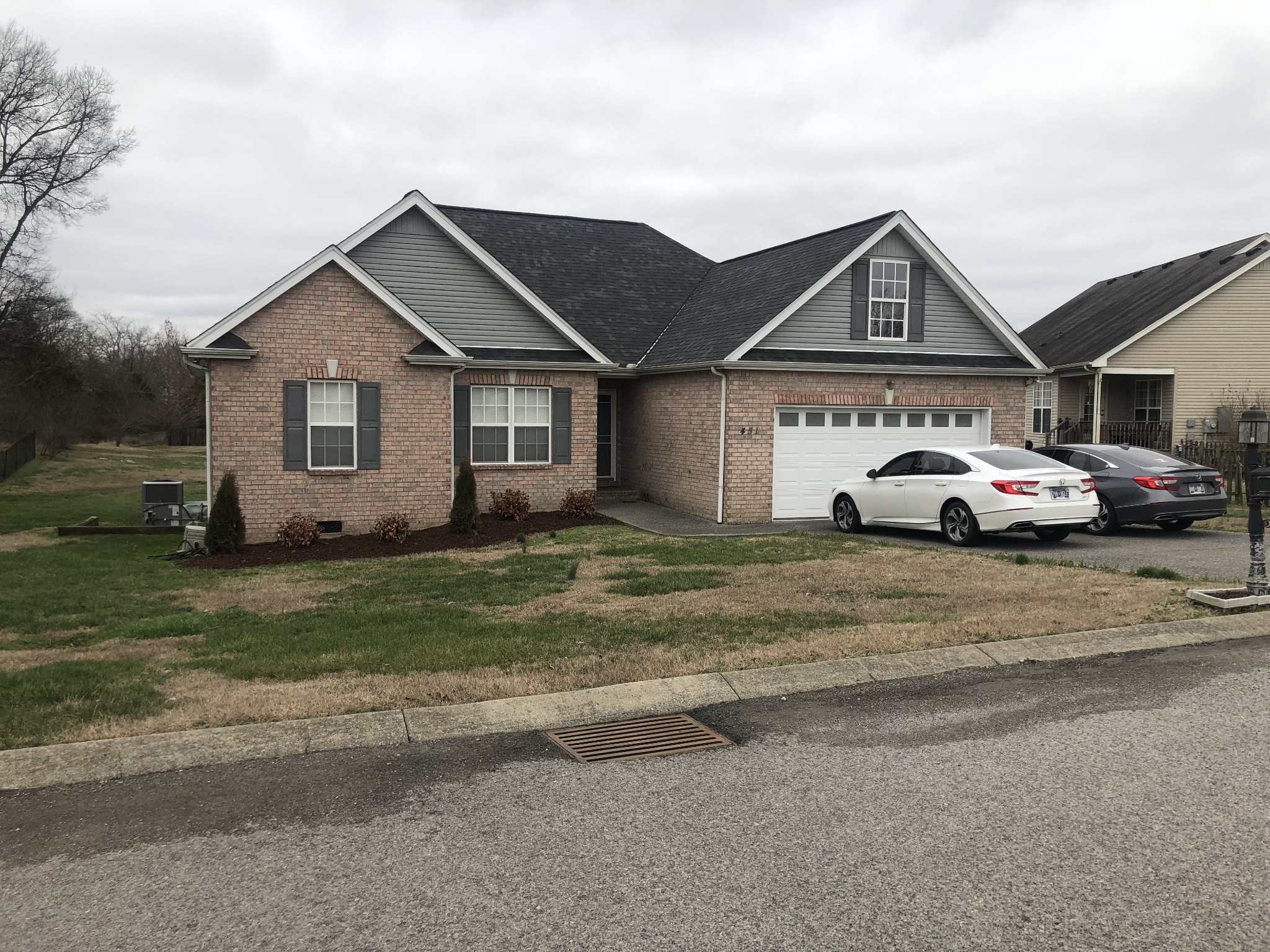 a front view of a house with a garden