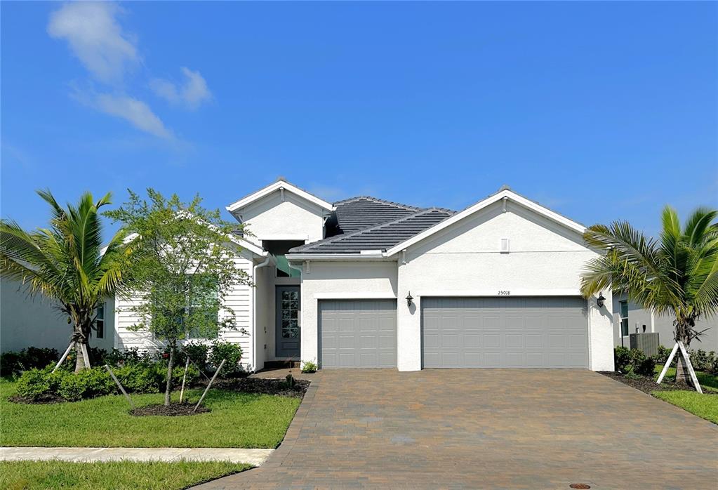 a front view of a house with a yard and garage