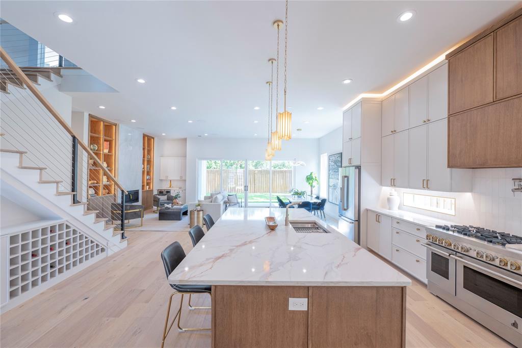 a kitchen with stainless steel appliances granite countertop a sink stove and cabinets