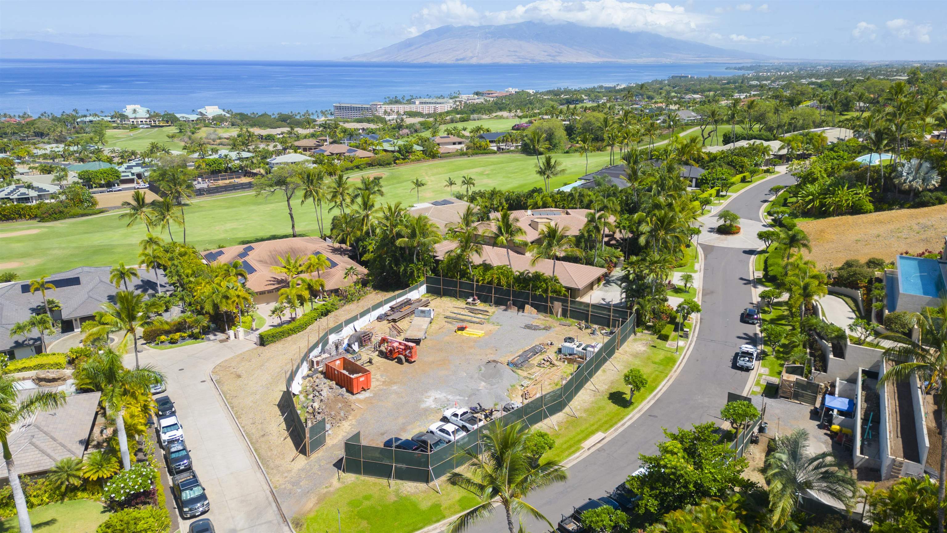 an aerial view of residential houses with outdoor space and ocean view