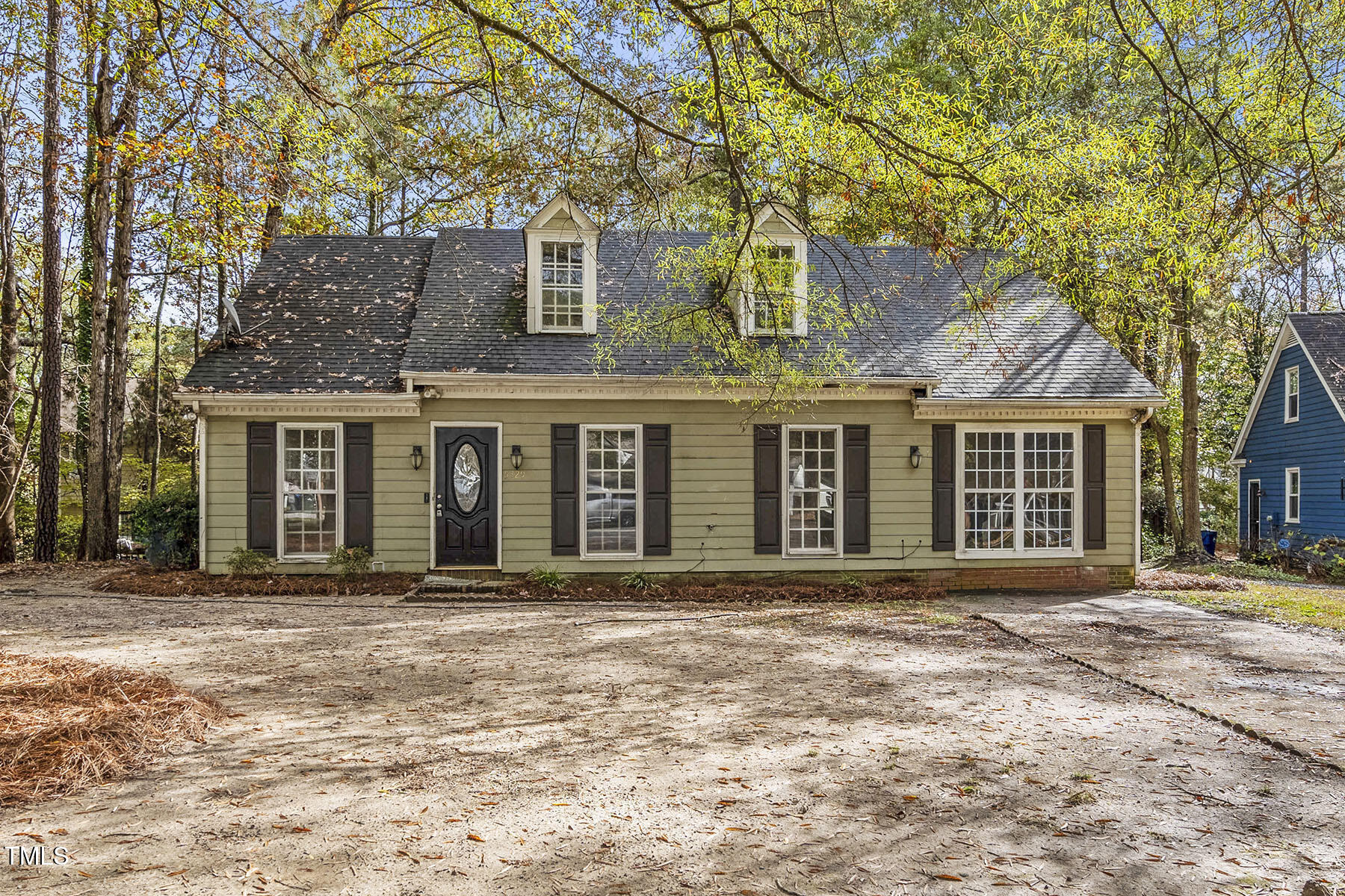 front view of a brick house with a large window