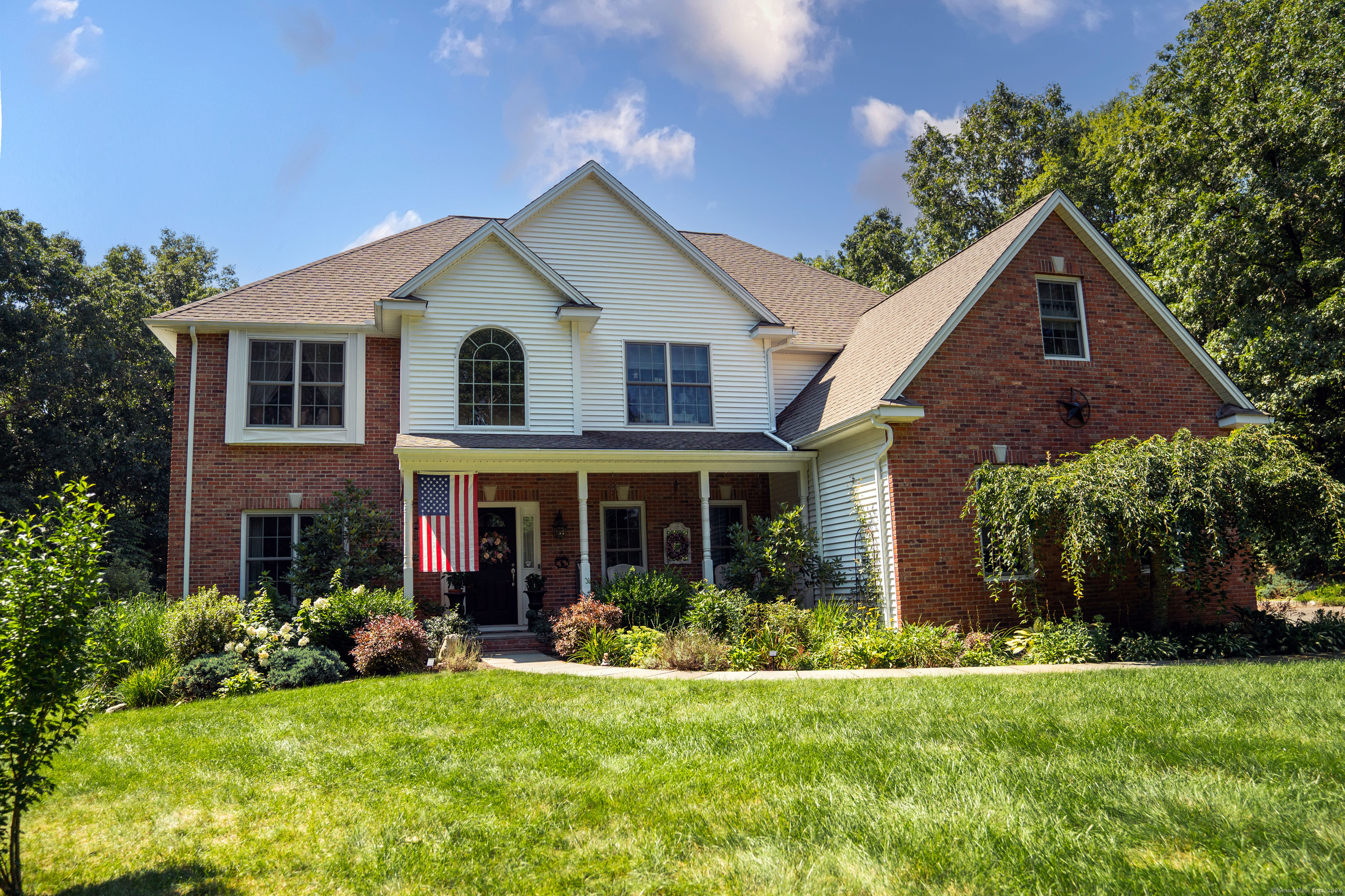 a front view of a house with a yard and porch