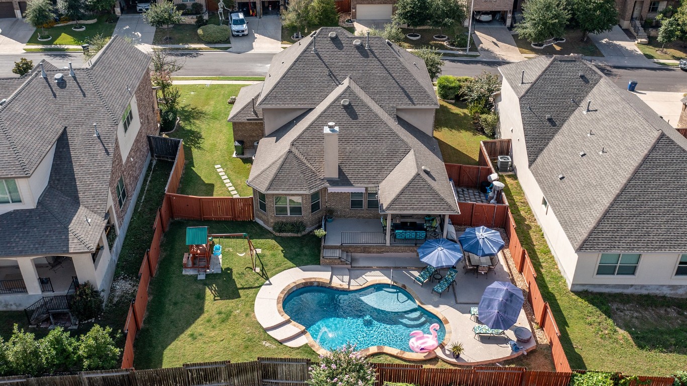 an aerial view of houses with swimming pool