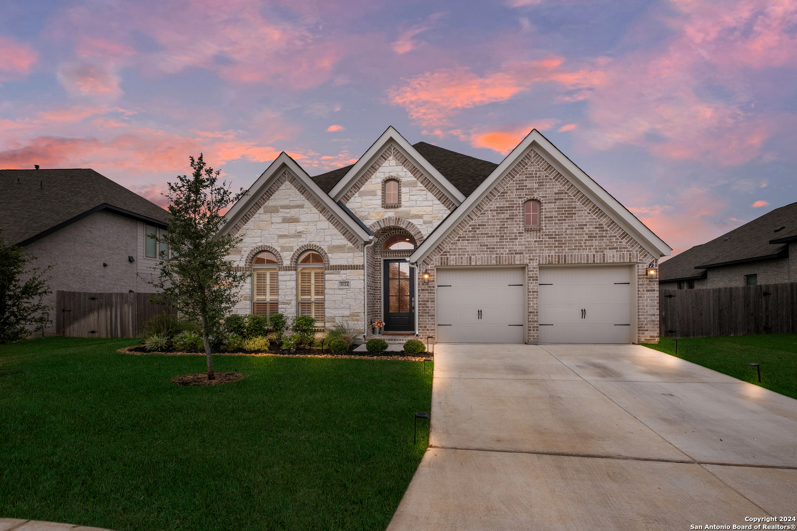 a front view of a house with a yard and garage