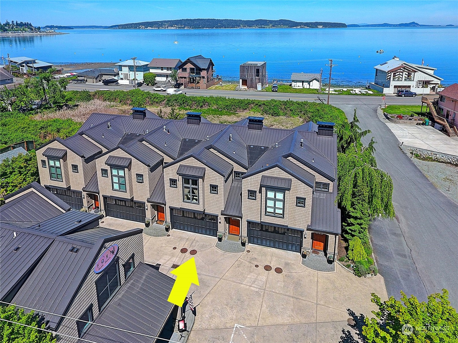 an aerial view of multiple houses with a yard