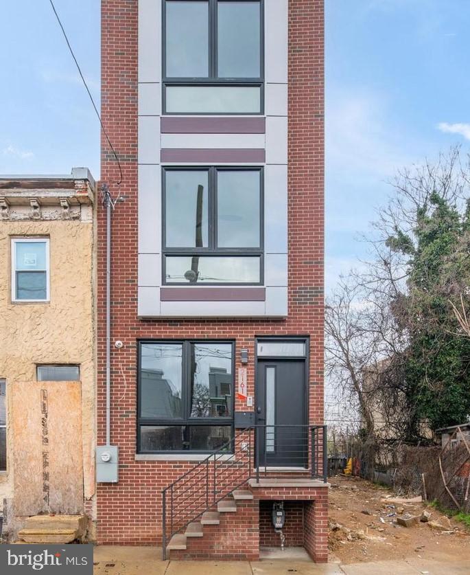 a view of a building with a window and a tree