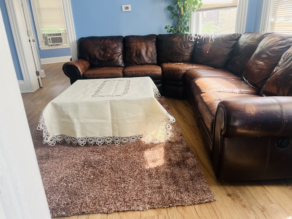 a living room with furniture and a rug