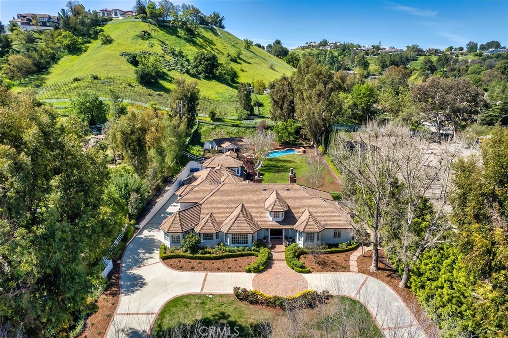 an aerial view of a house with yard swimming pool and outdoor seating