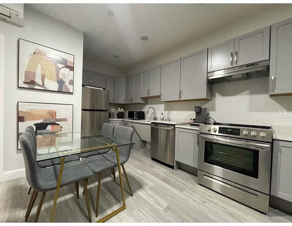 a kitchen with a stove refrigerator and cabinets