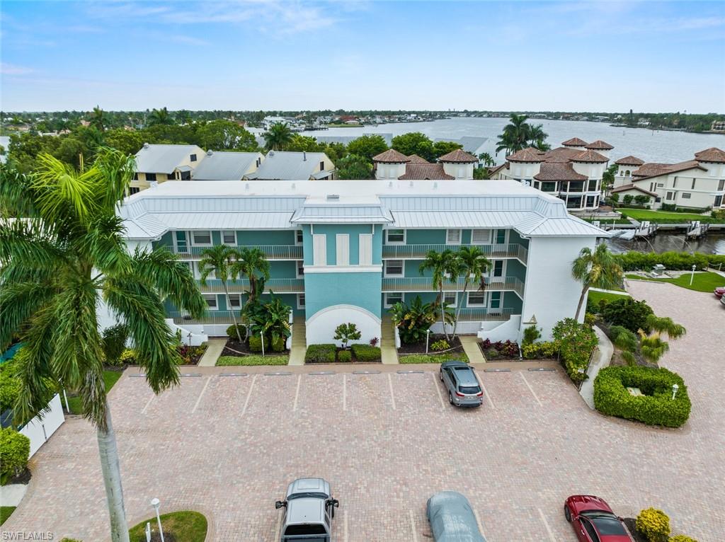 an aerial view of a house with a garden and lake view