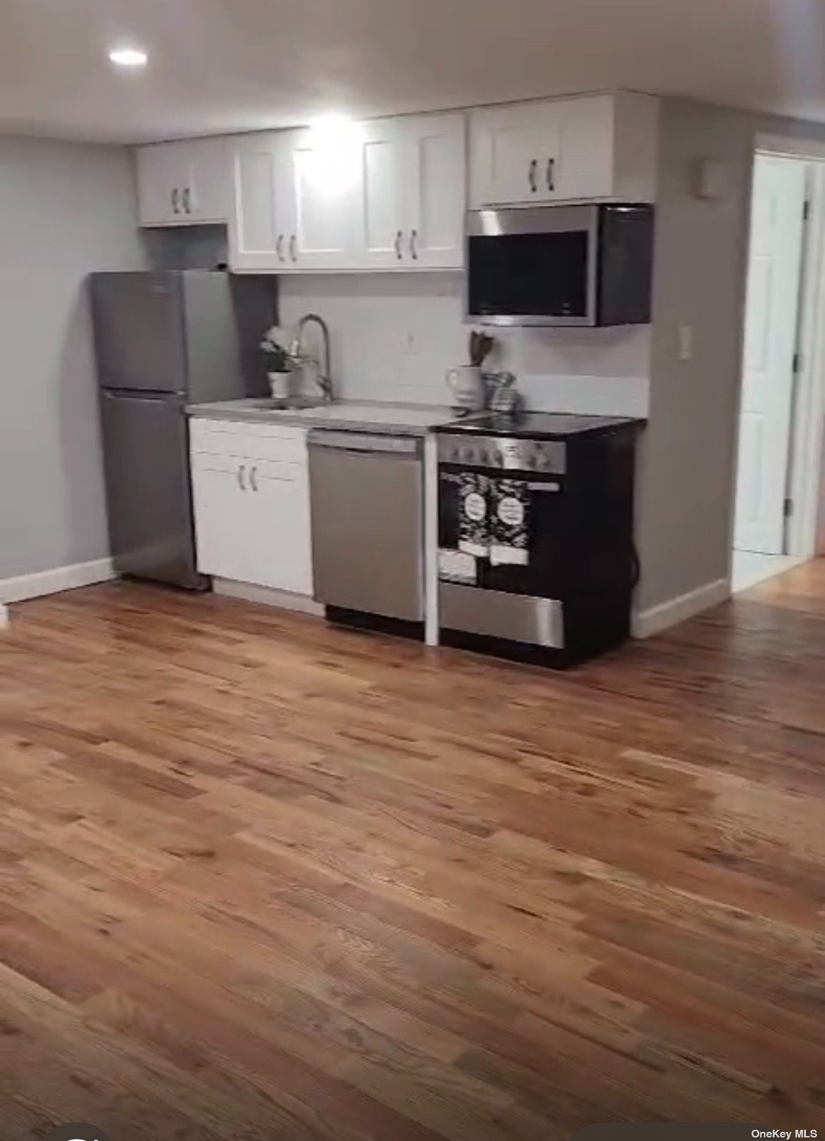 a kitchen with stainless steel appliances a refrigerator and a stove top oven