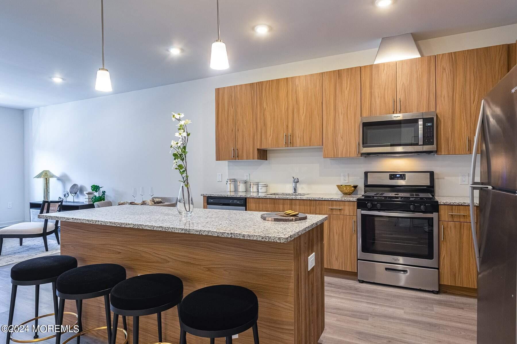 a kitchen with a stove a sink and a microwave