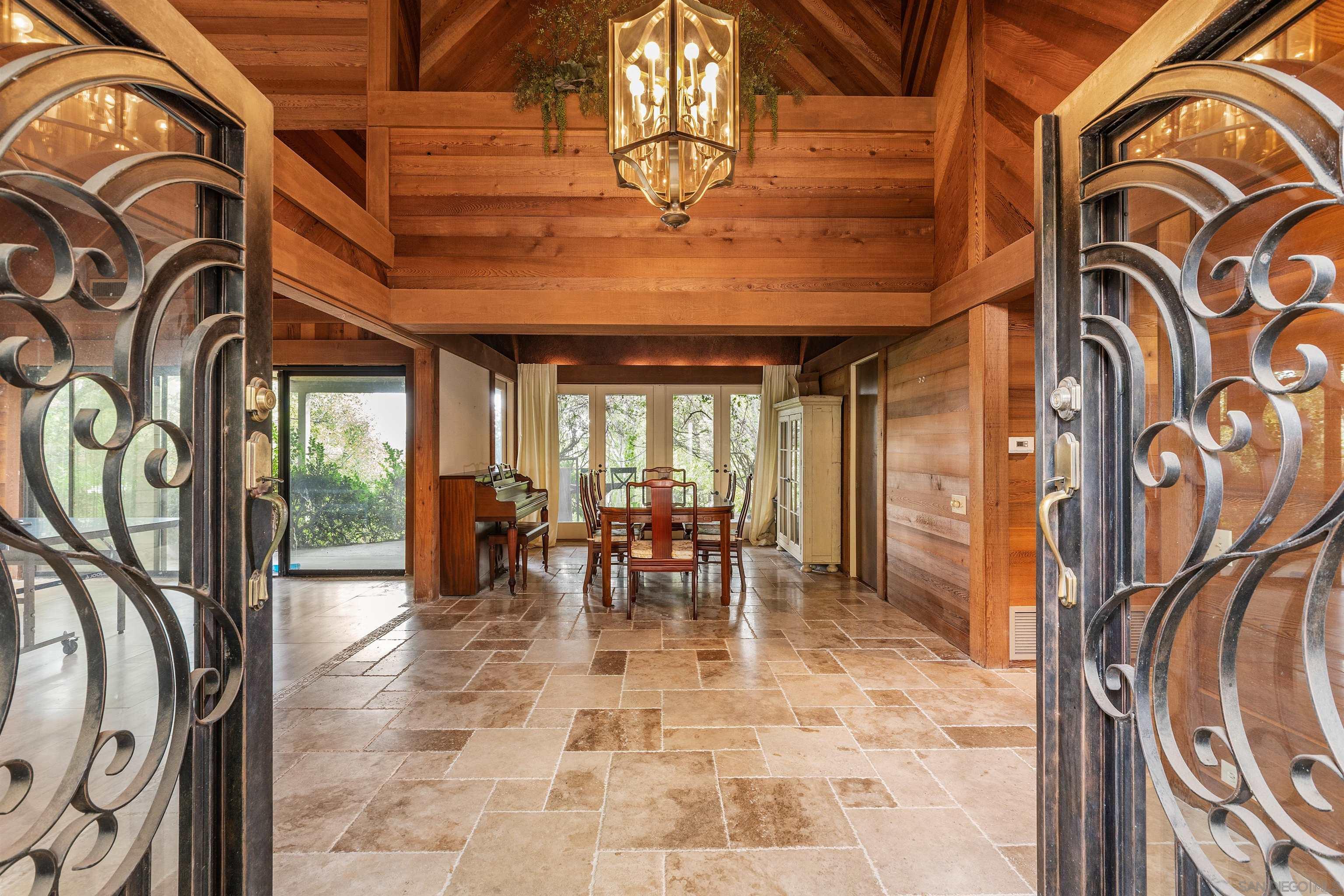 a dining room with furniture chandelier and a rug