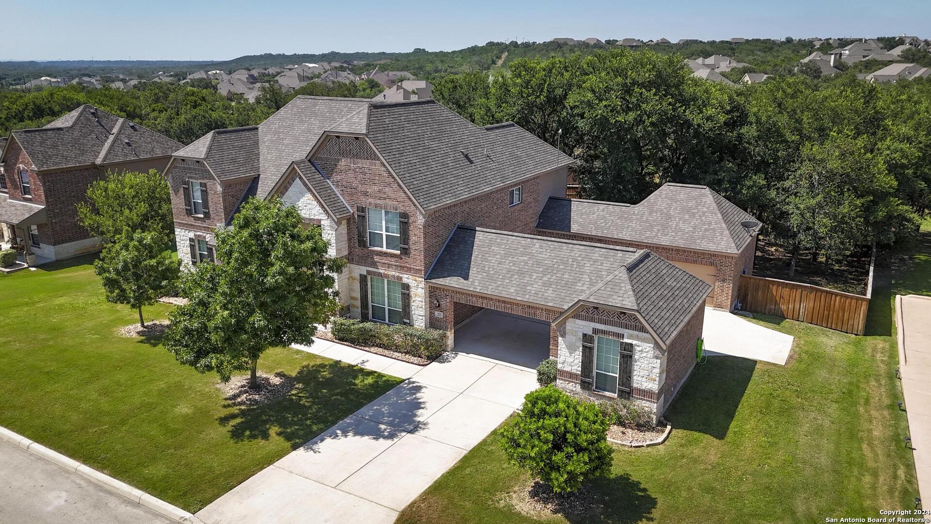 an aerial view of a house with a yard