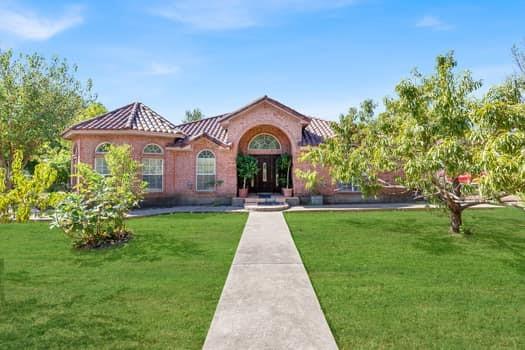 a front view of a house with garden