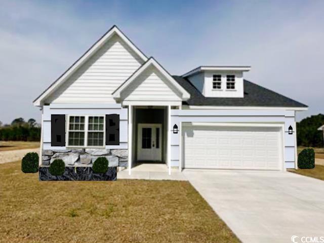 View of front of home with a garage and a front ya