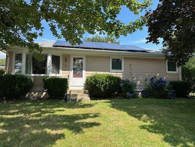 a view of a house with a yard and plants