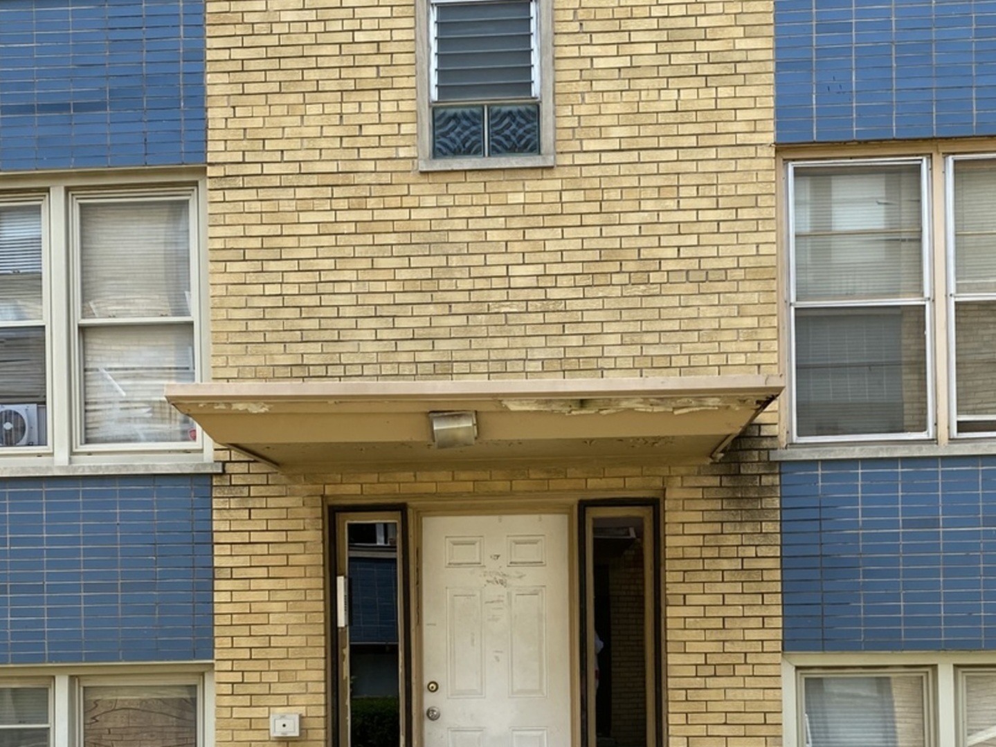 a view of a brick building with a door