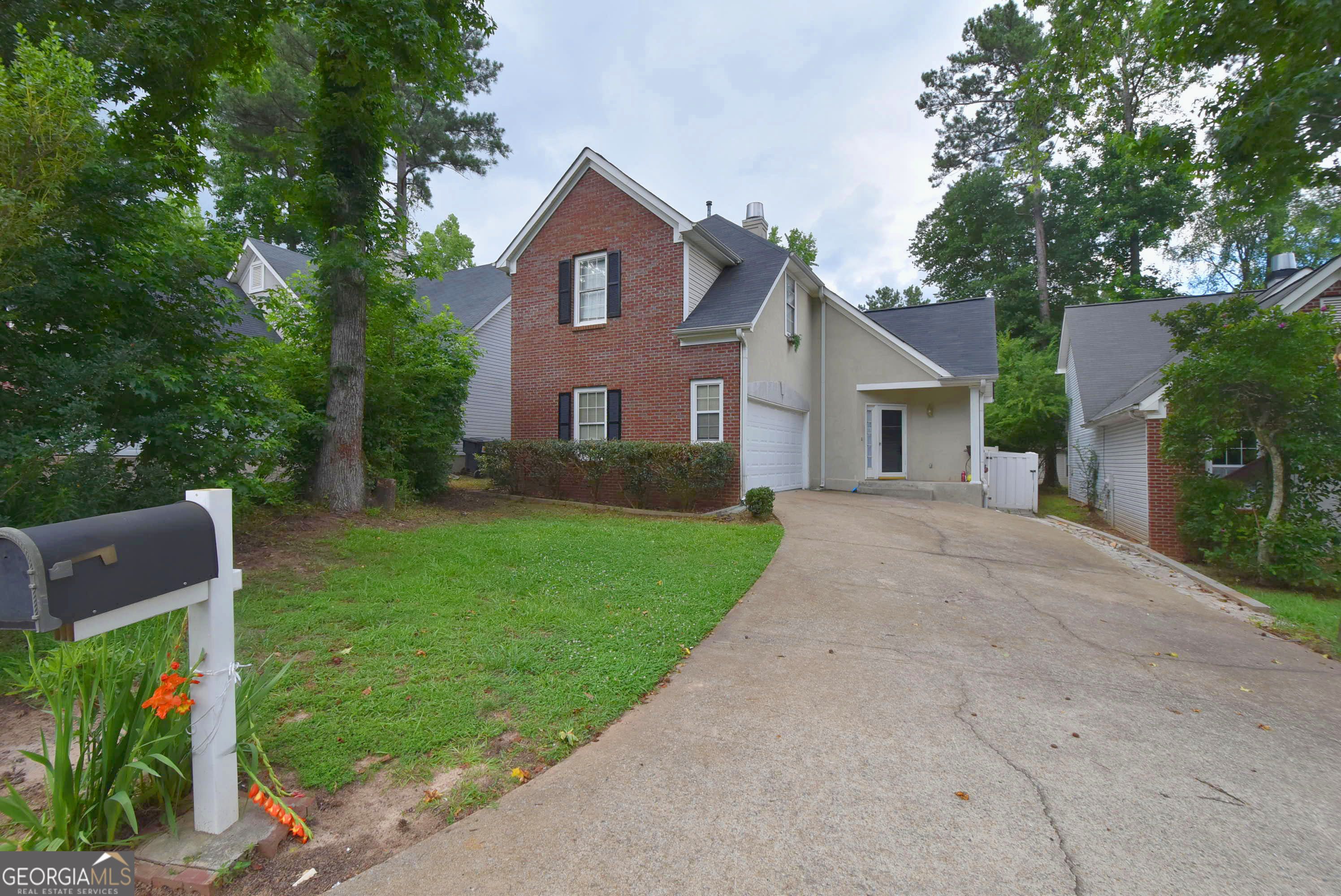 a front view of house with yard and green space