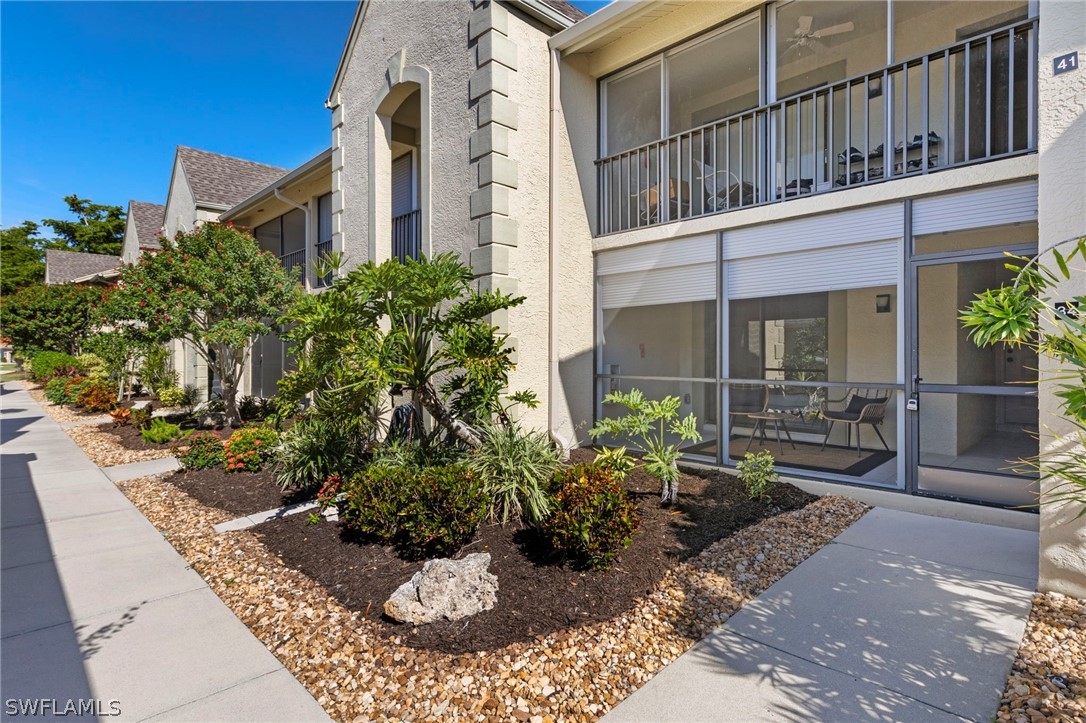 a view of a house with backyard and sitting area