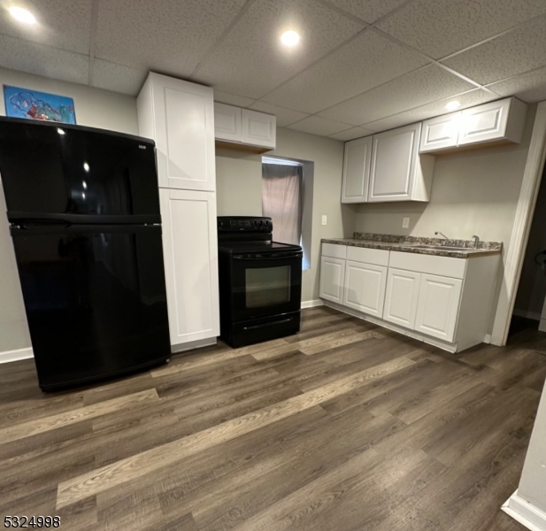 a kitchen with a sink and a refrigerator