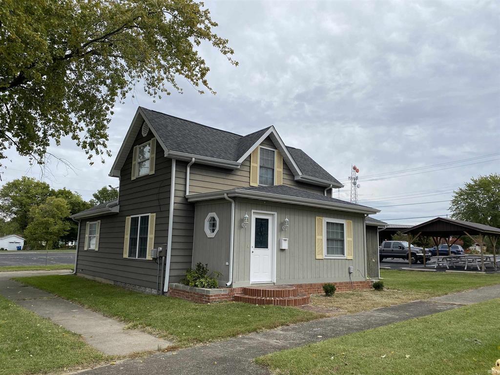 a front view of a house with a garden